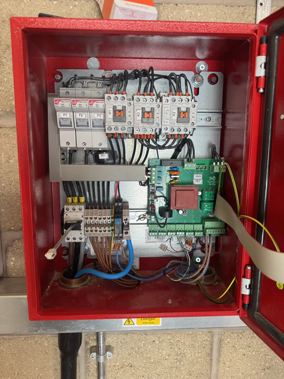 Fire pump control panel opened for diagnostics showing contactors, relays and the control card