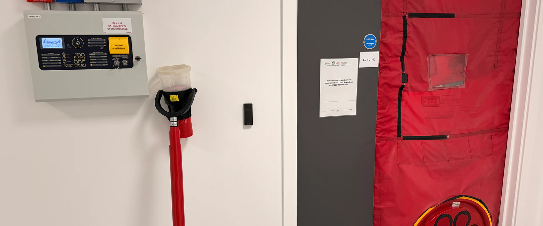 Gas suppression control panel and a room integrity door fan test in progress at a client server room