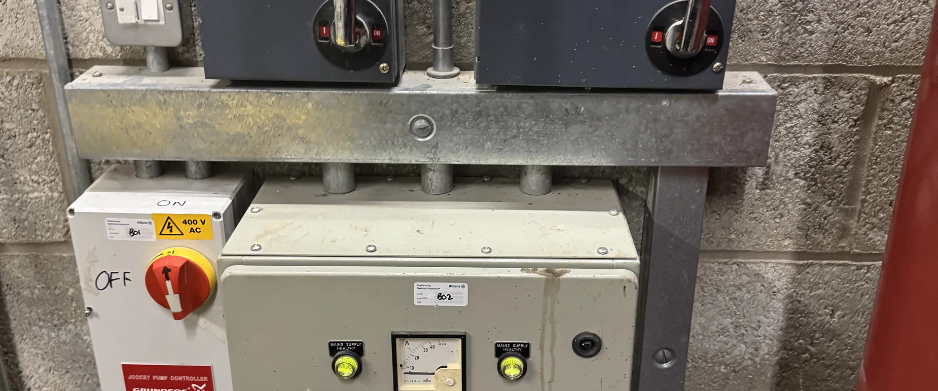 Fire pump isolators and jockey pump controller mounted in a sprinkler pump house