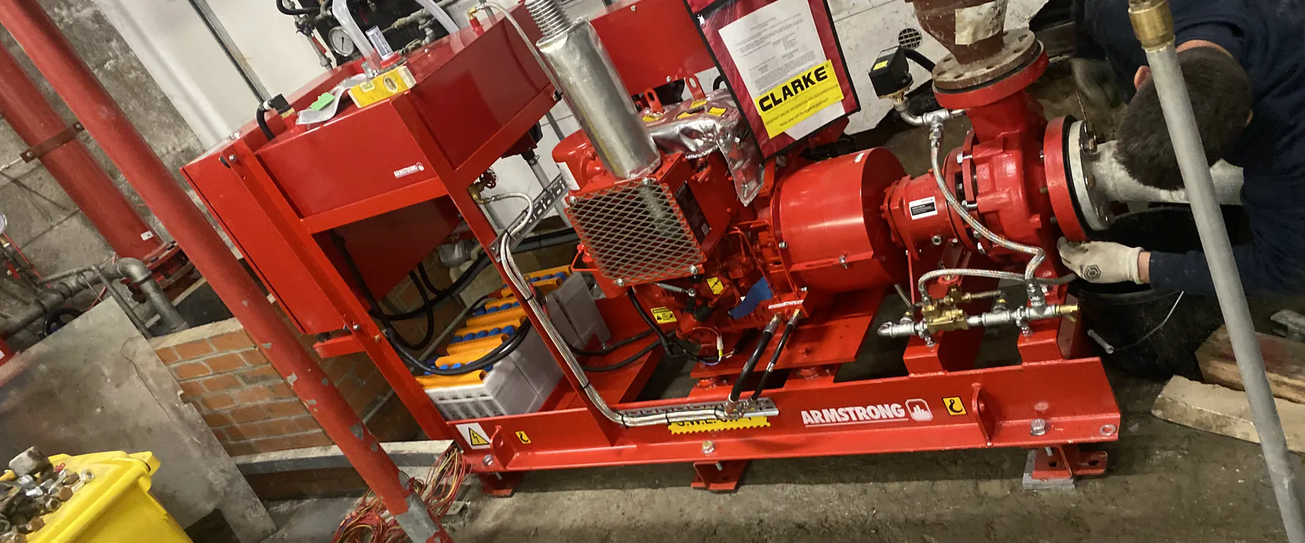 WSD engineer working on an Armstrong diesel fire pump set during a scheduled service visit